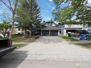 a house with a driveway in front of it at The Luxe Escape Calgary I 3BR Vacation Home in Calgary