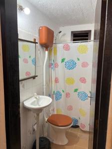a bathroom with a toilet and a sink at Cabañas Beija Flor Cabaña Nr 11 in Punta Del Diablo