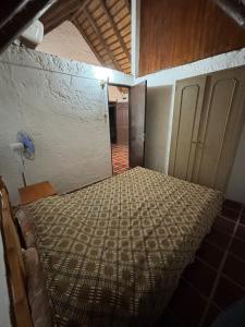 an empty room with a bed in a room at Cabañas Beija Flor Cabaña Nr 11 in Punta Del Diablo +2 photos