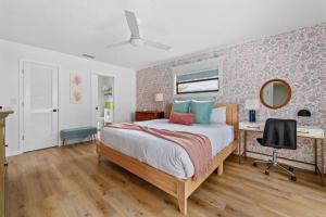 a bedroom with a bed and a desk and a mirror at Heated Pool Mini Golf Game Room Near Beaches in Bradenton +41 photos