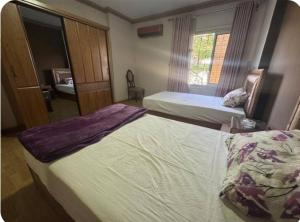 a hotel room with two beds and a window at The GEM Star House in Cairo