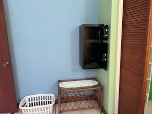a corner of a room with a tv and a shelf at Seaview Guesthouse Apt#1 in Bank Level