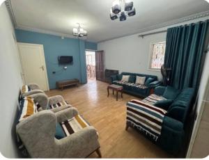 a living room with a couch and chairs at The GEM Star House in Cairo