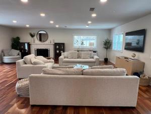 a large living room with two couches and a fireplace at Love at First Sight Retreat Luxury 4 bed 4 bath near DC Family Home in Annandale