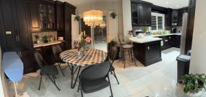 a kitchen with a table and chairs in a kitchen at F3 Spacious room with 2 queen beds and TV in Mississauga