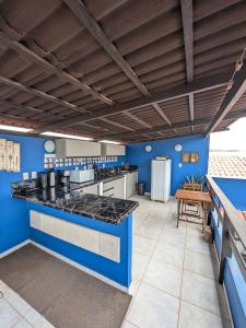 a kitchen with blue walls and a counter top at Pousada Costa Prestige in Touros