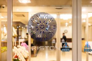 a sign on the window of a store at Natural Hot Spring Ariston Hotel Oita in Oita +65 photos