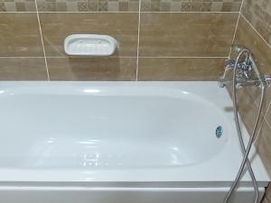 a bath tub in a bathroom with a shower at 2BD prime apartment in rehab city in New cairo +3 photos