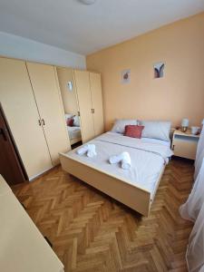 a bedroom with a large bed with towels on it at Apartment in Vidovac Cesaricki - Velebit Riviera 53369 in Vidovac +5 photos