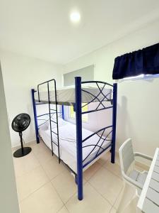 a room with two bunk beds and a chair at Ibiza Beach Residences in Río Hato +6 photos