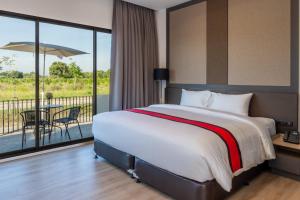 a bedroom with a large bed and a balcony at Pan Ville Resort in Pathum Thani +15 photos