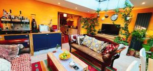 a living room with a couch and a table at Funky Urban Jungle in Cardiff