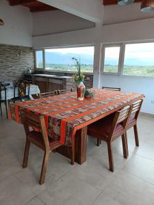a dining room table with a patterned table cloth on it at Casa del Pié del Cerro in San José
