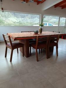 a dining room table with chairs and a table with at Casa del Pié del Cerro in San José +6 photos