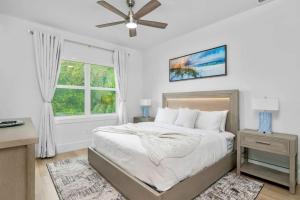 a bedroom with a bed and a window at Blue Diamond Beach Home in Bonita Springs +43 photos