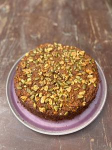a cake with nuts on top on a purple plate at Puemape Planet Eco Hostel in Puémape +7 photos