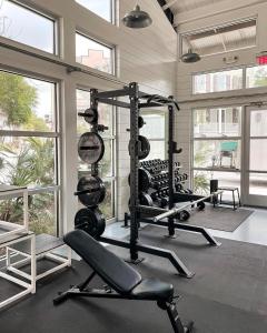a gym with several tread machines in a room with windows at Anchors Away in Park Circle with King Suite in Charleston
