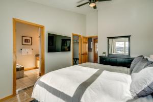 a bedroom with a large white bed with a window at 8 Mi to Keystone Mtn-View Ski Retreat! in Silverthorne
