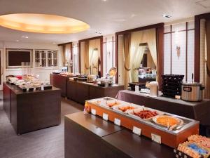 a restaurant with a buffet line with food on display at Hotel Grand Terrace Toyama in Toyama