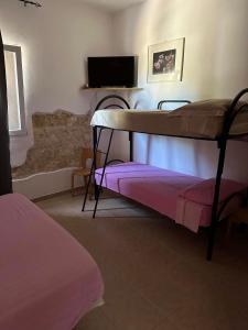 a bedroom with a bunk bed and a tv at B&B Angolo Magico in Baia Di Gallipoli