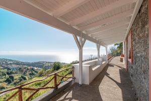 a view of the ocean from the balcony of a house at Vila Pitaias in Estreito da Calheta