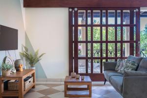 a living room with a couch and a sliding door at Elegant Getaway for Couples & Friends at Blue Bay in Willemstad