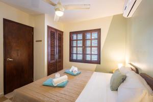 a bedroom with a bed with two pillows on it at Elegant Getaway for Couples & Friends at Blue Bay in Willemstad +30 photos