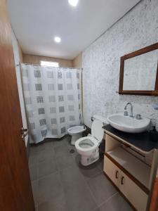 a bathroom with a toilet and a sink at Escapada perfecta con pileta privada- 2 personas in Ciudad Lujan de Cuyo