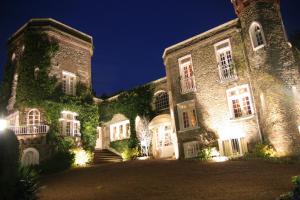 a large stone building with ivy on it at night at Domaine Saint Clair - Le Donjon in Étretat