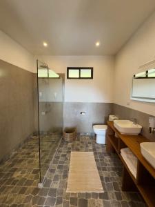a bathroom with a shower and a sink and a toilet at Finca Aquarius in Monteverde Costa Rica +27 photos