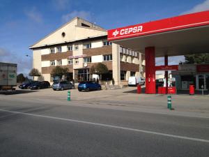 a gas station with cars parked in a parking lot at Hotel Venta Nueva in Calatañazor