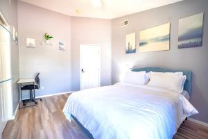 a bedroom with a large bed and a desk at Private Guestrooms OR Entire Home Rental in North Las Vegas in Las Vegas