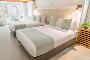 Una cama o camas en una habitación de Hotel Irotama Bungalows & Bohios