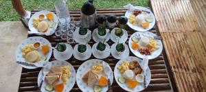 a group of plates of food on a wooden table at Haisa Apartment in Coron
