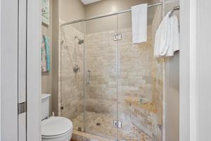 a bathroom with a glass shower with a toilet at No Car Needed King Bed Balcony Abercorn And York-2 in Savannah +23 photos
