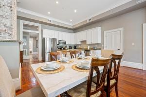 a kitchen and dining room with a table and chairs at No Car Needed King Bed Balcony Abercorn And York-2 in Savannah