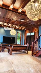 a living room with a large screen tv and a table at Earth Elements Eco Resort in Ban Bu Hua Chang
