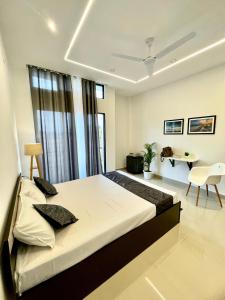 a bedroom with a large bed and a desk at Saya's Abode - Railview Suites in Tezpur +124 photos