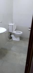 a white bathroom with a toilet and a sink at Stag Mountain Resort in Ettampitiya +9 photos