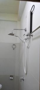 a shower in a bathroom with a phone on the wall at Stag Mountain Resort in Ettampitiya