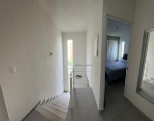 a hallway with a room with a bed and a mirror at Casa Terramar lll in Acapulco +2 photos