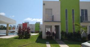 a green and white building with a swimming pool at Casa Terramar lll in Acapulco