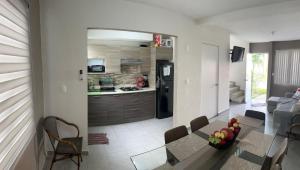 a kitchen and a living room with a table and chairs at Casa Terramar lll in Acapulco