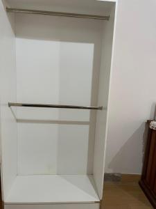 a white closet with a sliding glass door at APART LyM 1 in Clorinda