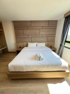 Postel nebo postele na pokoji v ubytování เวลโกรว์ โฮเทล - Wellgrow Hotel
