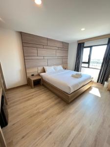 Postel nebo postele na pokoji v ubytování เวลโกรว์ โฮเทล - Wellgrow Hotel