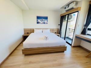 Postel nebo postele na pokoji v ubytování เวลโกรว์ โฮเทล - Wellgrow Hotel