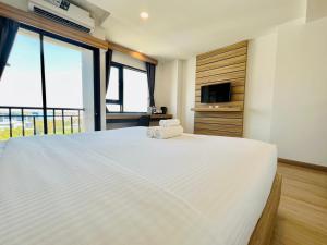 Postel nebo postele na pokoji v ubytování เวลโกรว์ โฮเทล - Wellgrow Hotel