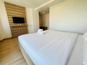 Postel nebo postele na pokoji v ubytování เวลโกรว์ โฮเทล - Wellgrow Hotel