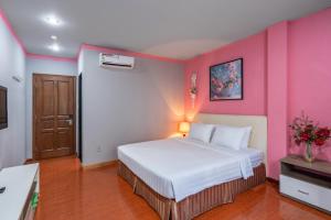 Postel nebo postele na pokoji v ubytování La Palma - Garden Saigon Hotel Phu My Hung + 12 fotografií